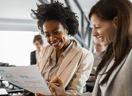 coworkers looking at sheet of paper